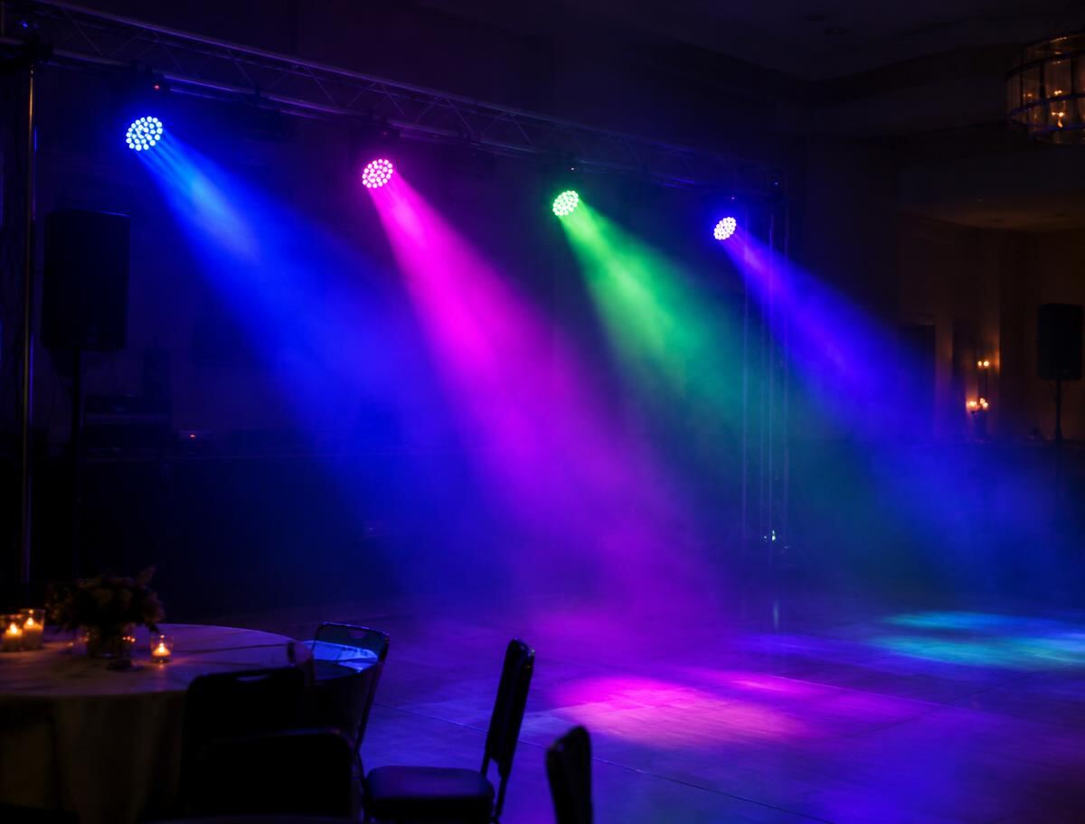 Coloured stage lighting beams through haze